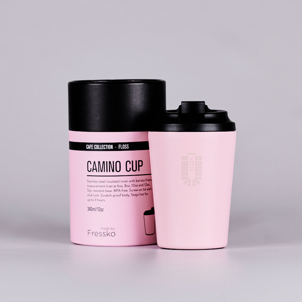 Pink reusable coffee cup with Senate Chamber seating plan, next to a pink cylindrical box.