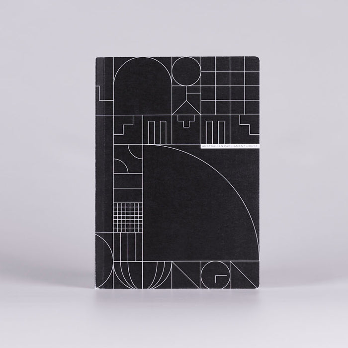 Front cover of a black notebook with a white geometric design.