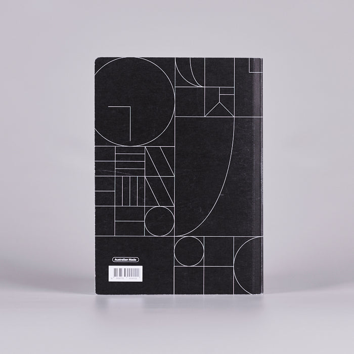Back cover of a black notebook with a white geometric design.