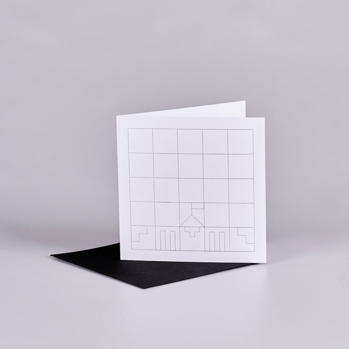 Square gift card with white background and a black grid design with a geometic Parliament House building in the lower half. The card is sitting on top of a black envelope.