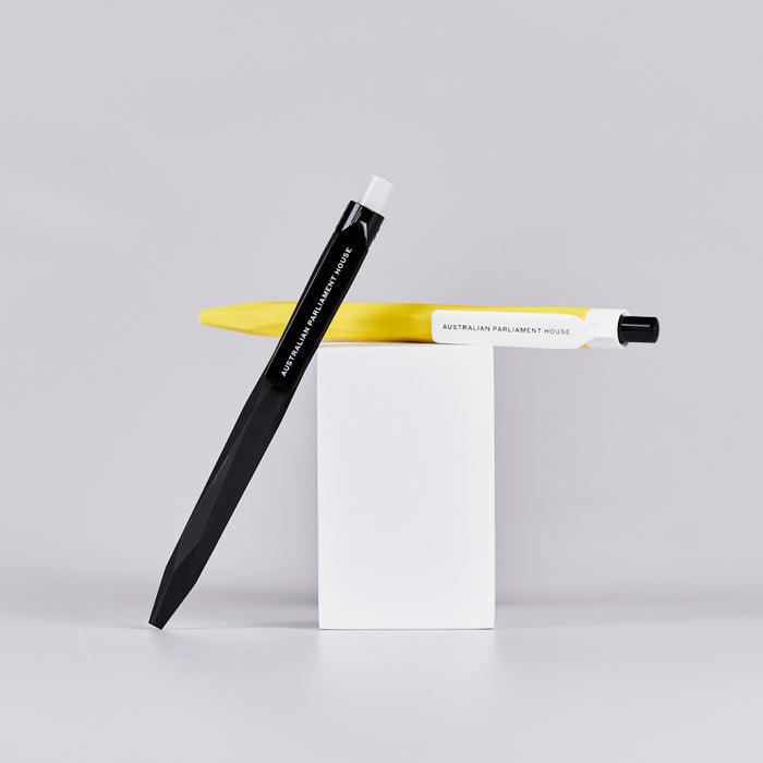 Two pens, one black and one yellow, with text reading 'Australian Parliament House' printed on them. 