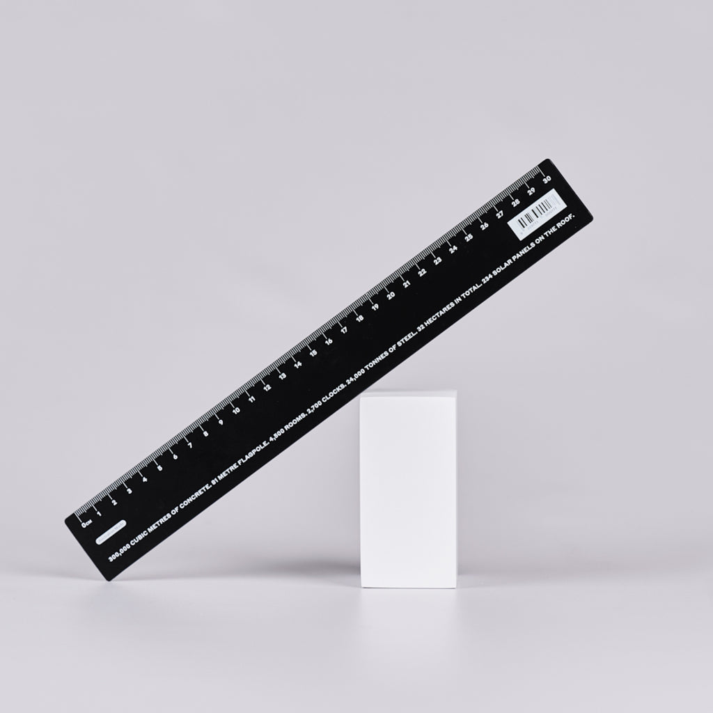 Black ruler with white numbers and text with statistics relating to Parliament House. There are 2,700 clocks. 