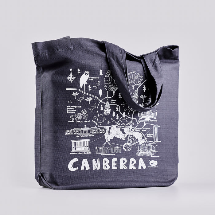 Navy tote bag with white illustrations of Canberra locations and the word 'Canberra'.