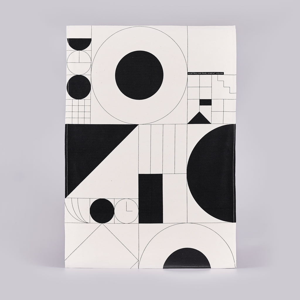 Tea towel with a black and white geometric design. 