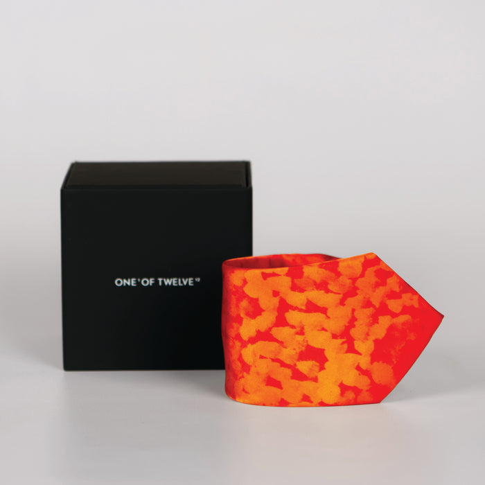 an orange colourful rolled tie and black display box