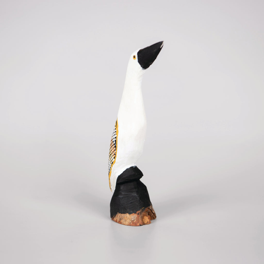 small black and white wooden bird sculpture