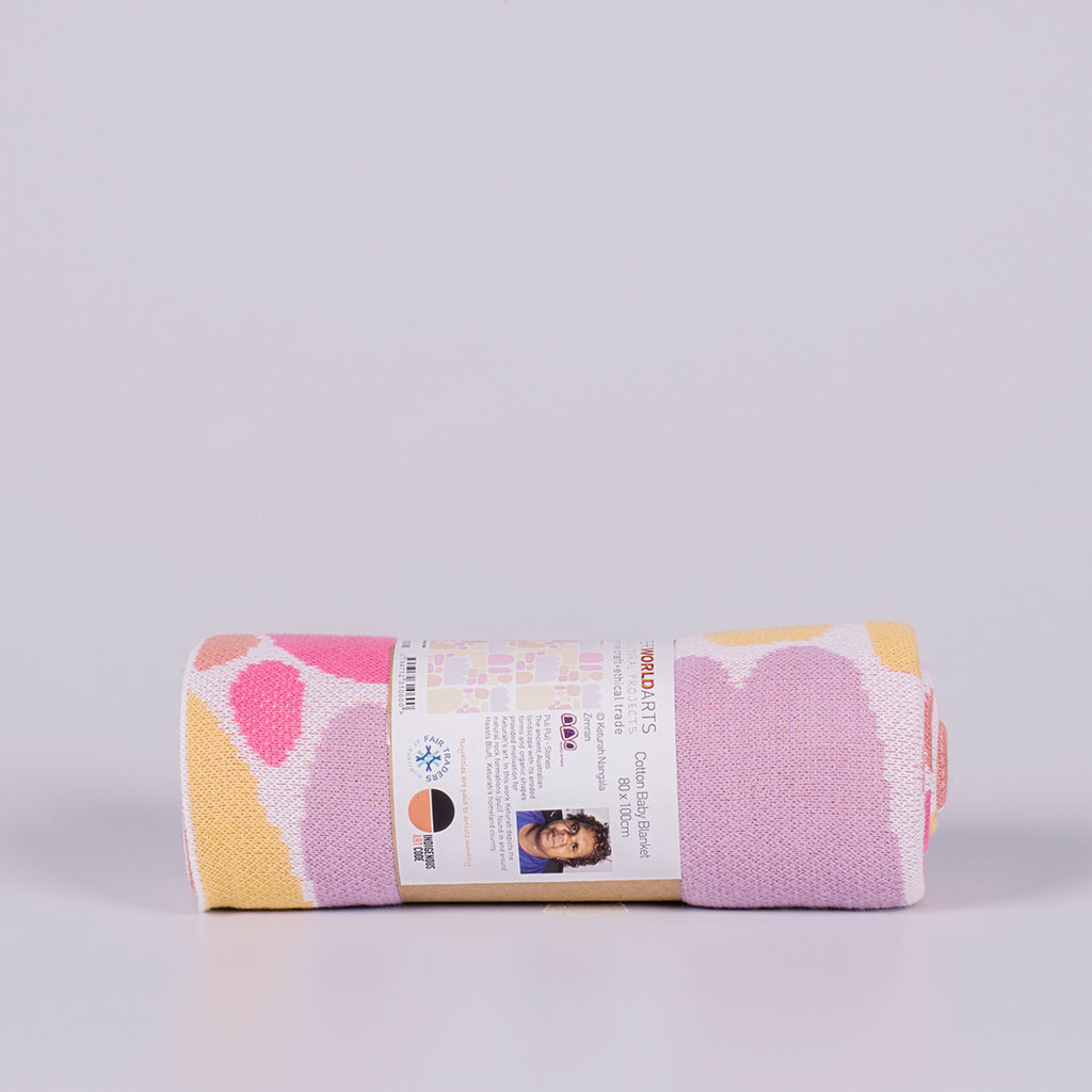 Rolled blanket featuring coloured shapes.