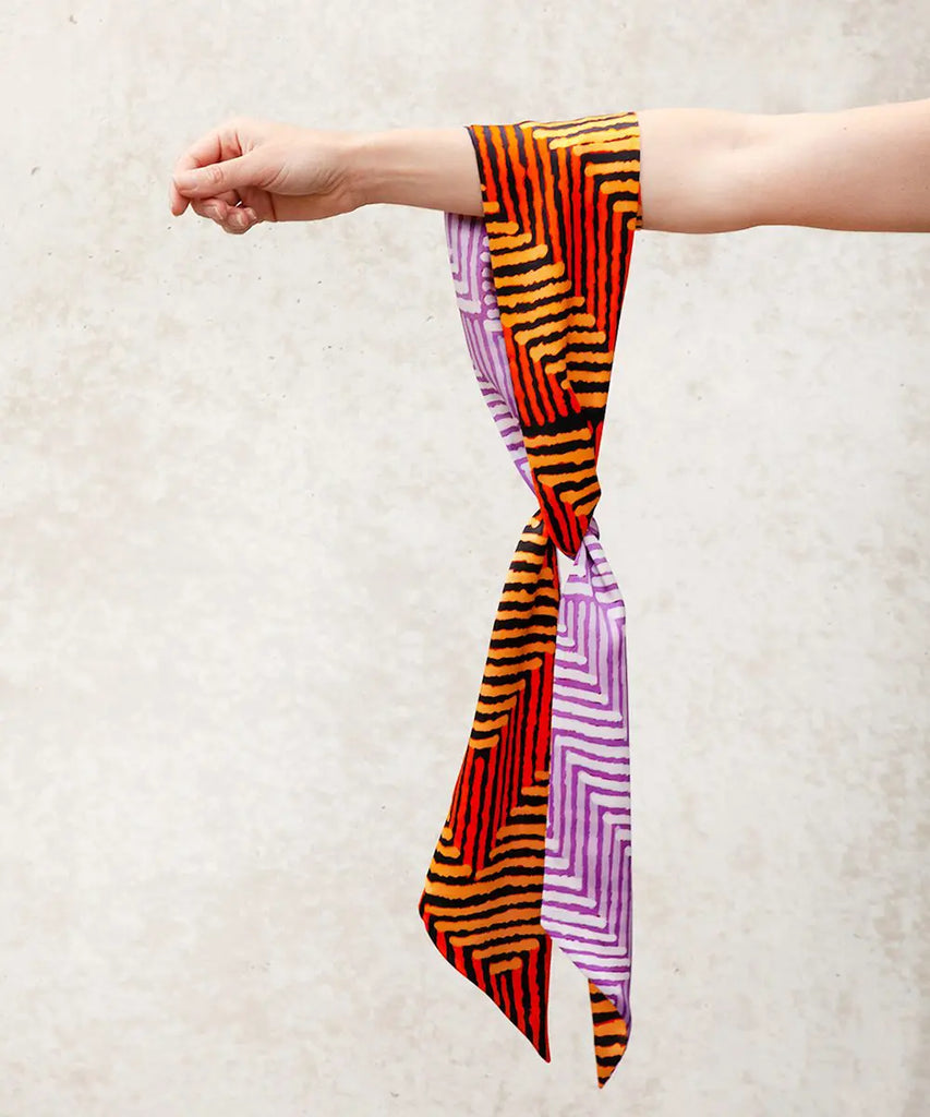 vibrant silk scarf hanging from an arm