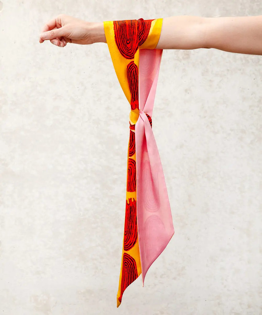 vibrant silk scarf hanging from an arm
